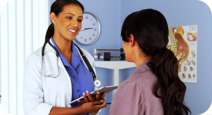 female doctor talking to a patient in her clinic
